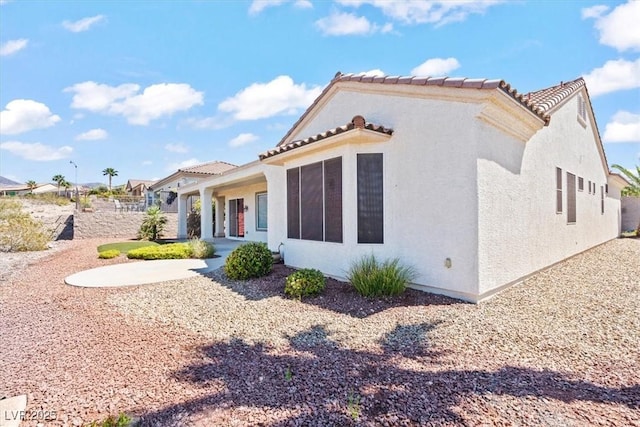 2868 Foxtail Creek Ave, Henderson, NV 89052 - view of side of property featuring stucco siding and a tile roof