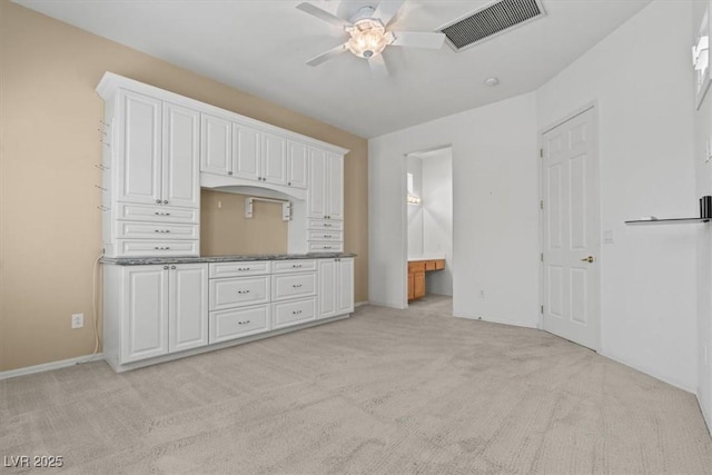 2868 Foxtail Creek Ave, Henderson, NV 89052 - interior space featuring light carpet, a ceiling fan, dark countertops, and white cabinets