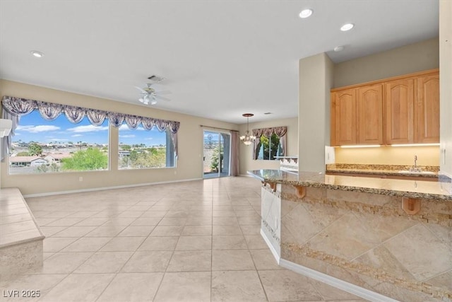 2868 Foxtail Creek Ave, Henderson, NV 89052 - kitchen with a chandelier, light stone countertops, light tile patterned floors, baseboards, and recessed lighting