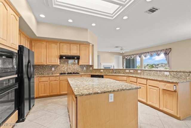 2868 Foxtail Creek Ave, Henderson, NV 89052 - kitchen with light brown cabinets, a kitchen island, black appliances, a sink, and light tile patterned flooring