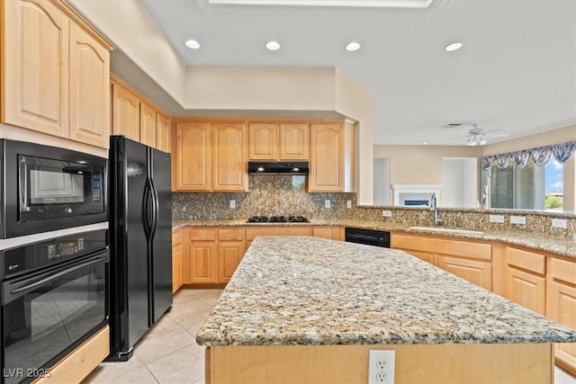 2868 Foxtail Creek Ave, Henderson, NV 89052 - kitchen with light brown cabinetry, black appliances, a sink, under cabinet range hood, and recessed lighting