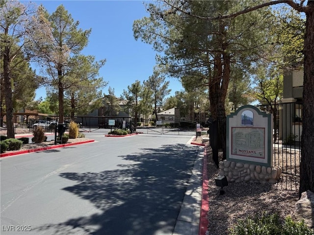 555 E Silverado Ranch Blvd Unit 2052, Las Vegas, NV 89183 - view of asphalt road with curbs, a gate, and a gated entry