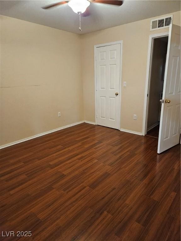 555 E Silverado Ranch Blvd Unit 2052, Las Vegas, NV 89183 - unfurnished bedroom with dark wood-style flooring, baseboards, and a ceiling fan