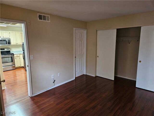 555 E Silverado Ranch Blvd Unit 2052, Las Vegas, NV 89183 - unfurnished bedroom with wood finished floors, a closet, and baseboards