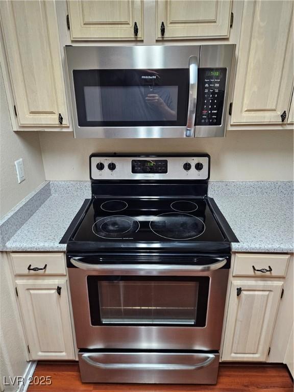 555 E Silverado Ranch Blvd Unit 2052, Las Vegas, NV 89183 - kitchen featuring appliances with stainless steel finishes, light stone counters, and wood finished floors
