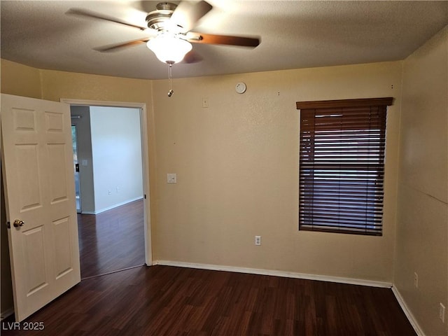 555 E Silverado Ranch Blvd Unit 2052, Las Vegas, NV 89183 - spare room with dark wood-type flooring, a ceiling fan, and baseboards