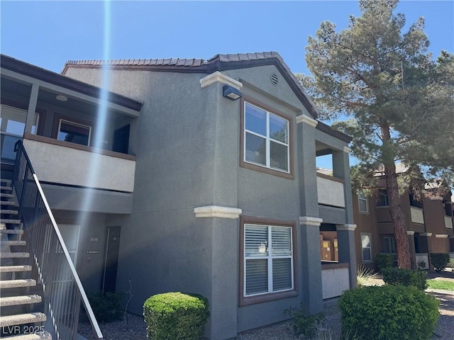 555 E Silverado Ranch Blvd Unit 2052, Las Vegas, NV 89183 - view of side of home featuring stairway and stucco siding