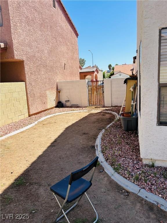 view of yard with fence and a gate