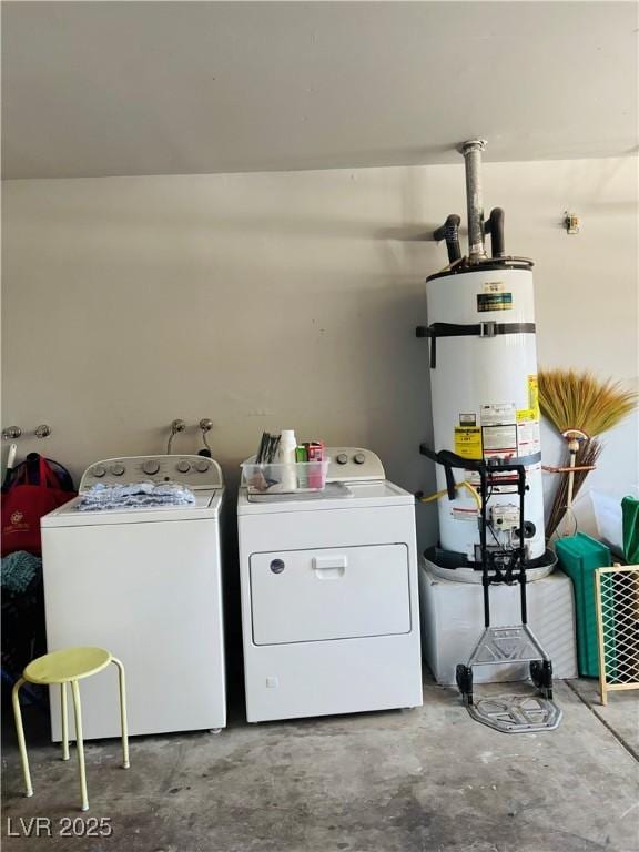 clothes washing area featuring washer and clothes dryer and strapped water heater