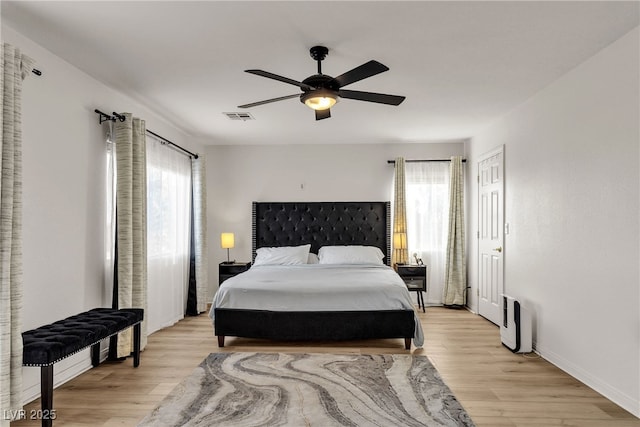 bedroom featuring light wood-type flooring, ceiling fan, and baseboards