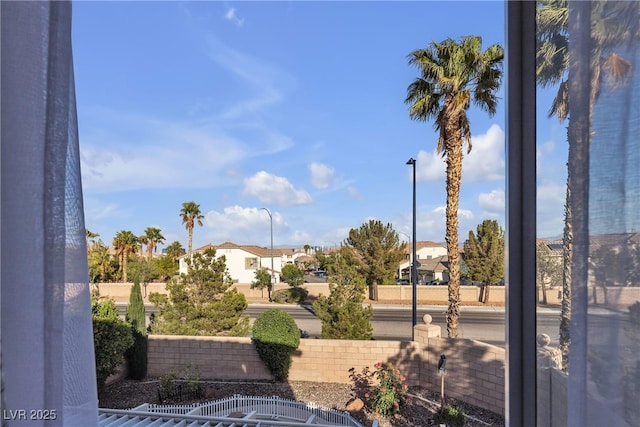 view of yard featuring fence and a residential view