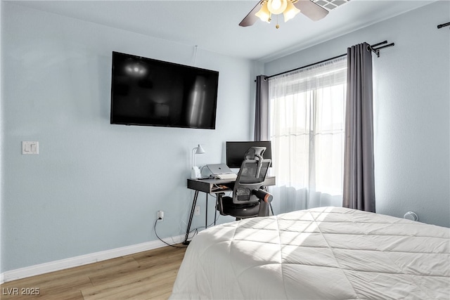 bedroom with wood finished floors, baseboards, and ceiling fan