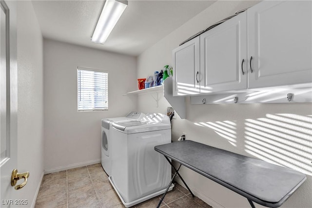 clothes washing area featuring cabinet space, separate washer and dryer, and baseboards