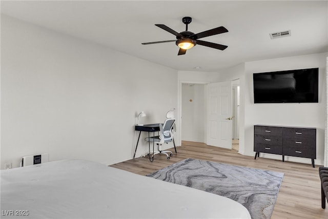 bedroom featuring wood finished floors, a ceiling fan, and baseboards