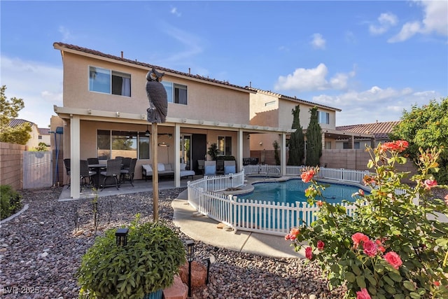 back of house featuring a fenced backyard, stucco siding, and a patio