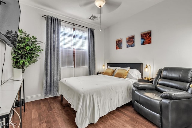 bedroom with dark wood-type flooring, baseboards, and ceiling fan