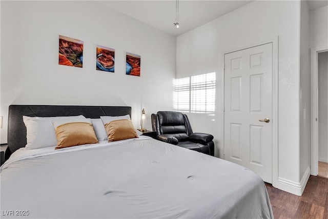 bedroom featuring dark wood-style flooring and baseboards