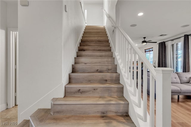 staircase featuring a ceiling fan, recessed lighting, and wood finished floors