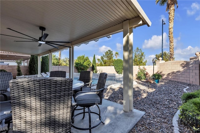 view of patio featuring ceiling fan, a fenced backyard, and outdoor dining area