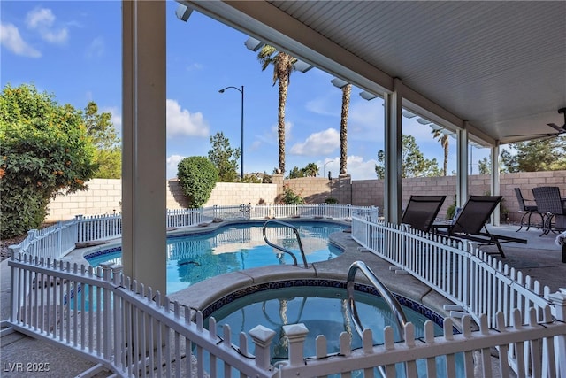 view of swimming pool with a fenced backyard, a patio, and a pool with connected hot tub