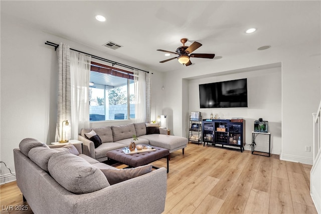 living room with ceiling fan, light wood-style flooring, recessed lighting, and baseboards