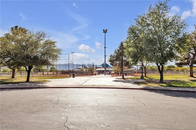 view of asphalt road with sidewalks and curbs