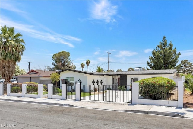 single story home with a fenced front yard, stucco siding, and a gate