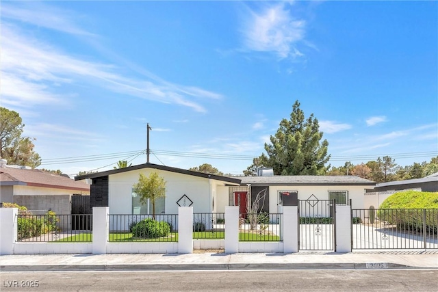 view of front of home with a fenced front yard and stucco siding