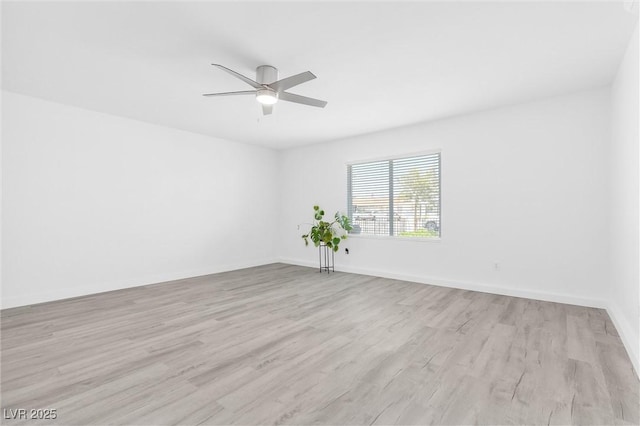 unfurnished room featuring light wood-style floors, a ceiling fan, and baseboards