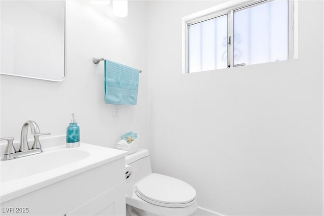 bathroom featuring toilet and vanity