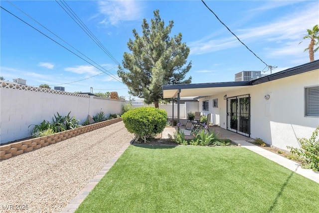 view of yard with a patio area and central AC