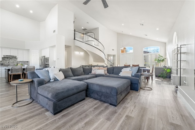 5684 Benevento Ct, Las Vegas, NV 89141 - living room featuring light wood-style floors, stairs, high vaulted ceiling, recessed lighting, and a ceiling fan