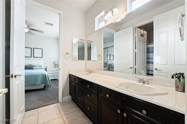 5684 Benevento Ct, Las Vegas, NV 89141 - bathroom featuring ensuite bath, double vanity, tile patterned flooring, baseboards, and ceiling fan