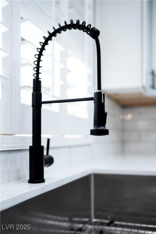 kitchen view of a sink and light countertops