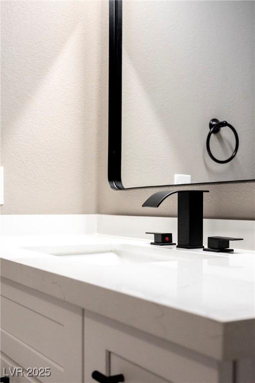 bathroom view of a textured wall and vanity