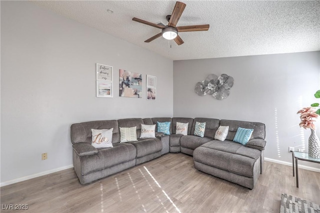 6408 Deadwood Rd, Las Vegas, NV 89108 - living room with a ceiling fan, a textured ceiling, wood finished floors, and baseboards
