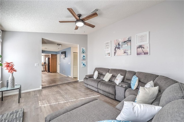 6408 Deadwood Rd, Las Vegas, NV 89108 - living area with a ceiling fan, wood finished floors, a textured ceiling, lofted ceiling, and baseboards