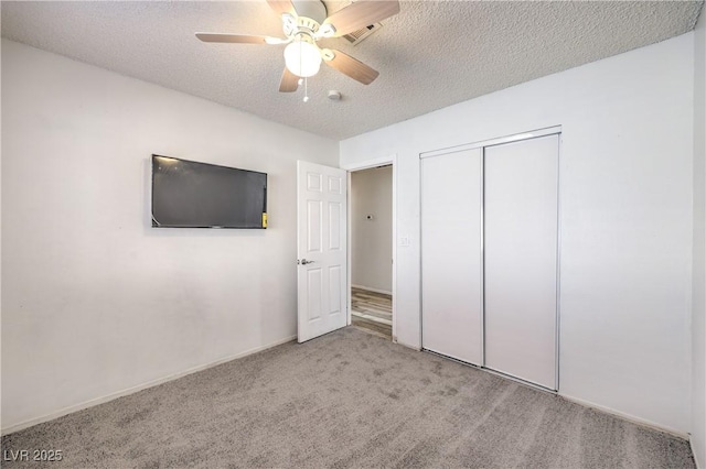 6408 Deadwood Rd, Las Vegas, NV 89108 - unfurnished bedroom featuring carpet floors, a textured ceiling, a closet, ceiling fan, and baseboards