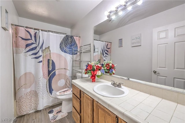 6408 Deadwood Rd, Las Vegas, NV 89108 - full bathroom featuring wood finished floors, vanity, and toilet