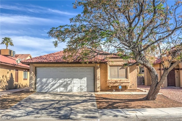 6408 Deadwood Rd, Las Vegas, NV 89108 - view of front of home with a garage, concrete driveway, stucco siding, and a tile roof