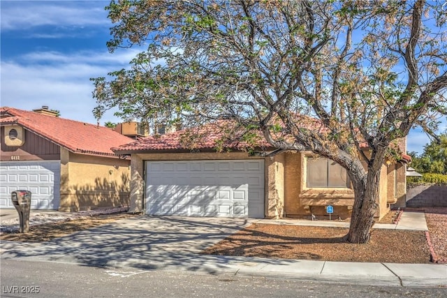 6408 Deadwood Rd, Las Vegas, NV 89108 - view of front of property with an attached garage, driveway, stucco siding, and a tile roof