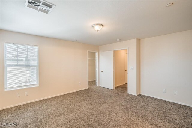 carpeted empty room with baseboards