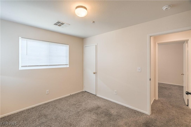 carpeted spare room with a smoke detector and baseboards