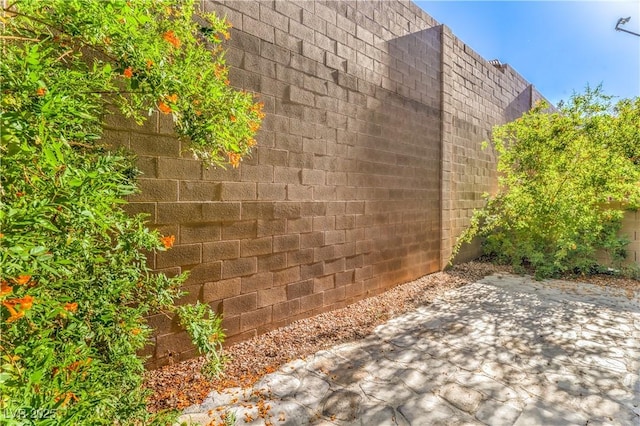 view of side of property with fence and a patio