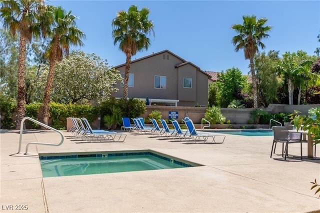 community pool featuring a patio area and fence
