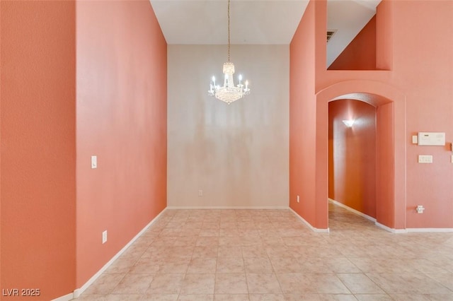 2587 Grizzly Park Ct, Henderson, NV 89052 - unfurnished room featuring arched walkways, a chandelier, and baseboards