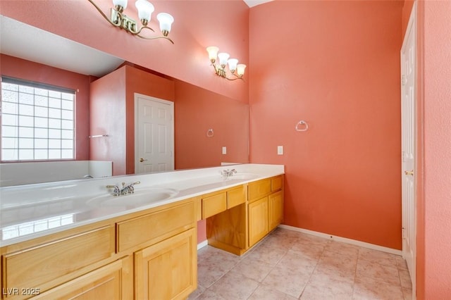 2587 Grizzly Park Ct, Henderson, NV 89052 - bathroom featuring double vanity, a chandelier, tile patterned floors, and baseboards