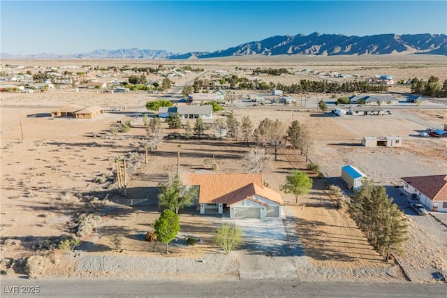 aerial view of sparsely populated area featuring a desert landscape and mountains