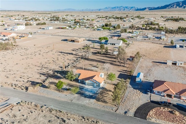 aerial view of a desert landscape and a mountainous background