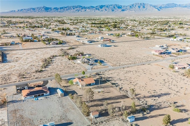 drone / aerial view of a desert landscape and a mountain backdrop